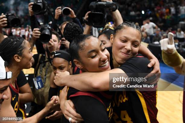 JuJu Watkins and Kaitlyn Davis of the USC Trojans celebrate a 74-61 victory over the Stanford Cardinal in the championship game of the Pac-12...