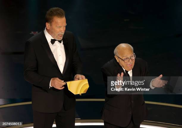 Arnold Schwarzenegger and Danny DeVito speak onstage during the 96th Annual Academy Awards at Dolby Theatre on March 10, 2024 in Hollywood,...