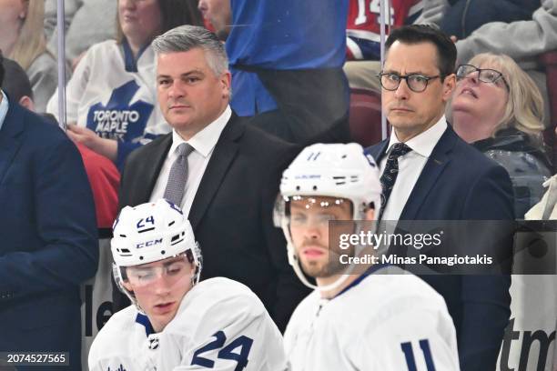 Head coach Sheldon Keefe and assistant coach of the Toronto Maple Leafs Guy Boucher, look on from the bench during the first period against the...