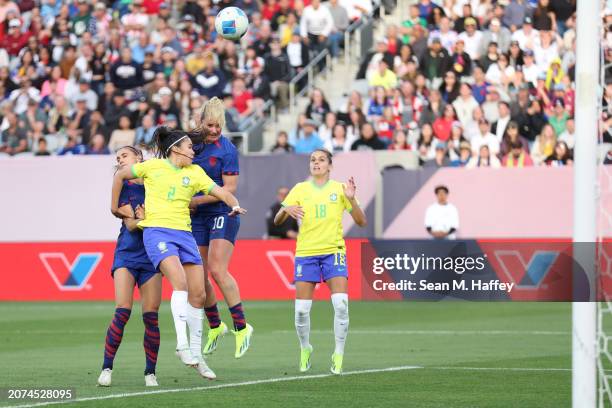 Lindsey Horan of the United States wins a header and scores a goal over Antonia of Brazil during the first half of the 2024 Concacaf W Gold Cup Final...