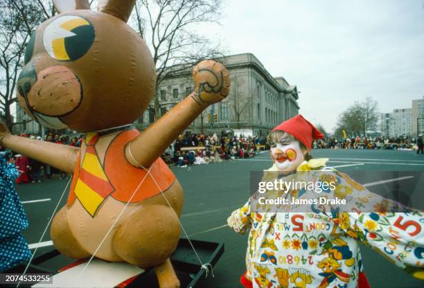 Clown helps pull a rabbit parade float near Twentieth Street and the Benjamin Franklin Parkway during the annual Thanksgiving Day Parade on November...