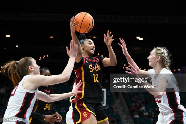 JuJu Watkins of the USC Trojans is defended by Elena Bosgana and Cameron Brink of the Stanford Cardinal in the second half of the championship game...