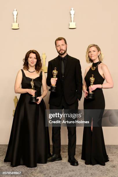 Raney Aronson-Rath, Mstyslav Chernov, and Michelle Mizner, winners of the Best Documentary Feature Film for “20 Days in Mariupol”, pose in the press...