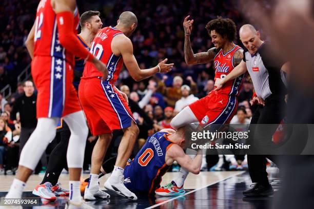 Donte DiVincenzo of the New York Knicks grabs Kelly Oubre Jr. #9 of the Philadelphia 76ers starting an altercation during the second half at Madison...