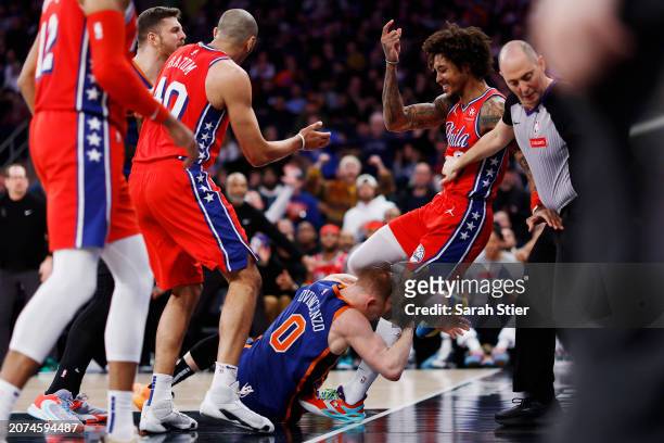 Donte DiVincenzo of the New York Knicks grabs Kelly Oubre Jr. #9 of the Philadelphia 76ers starting an altercation during the second half at Madison...
