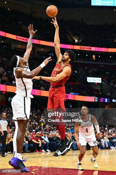 Jarrett Allen of the Cleveland Cavaliers shoots over Day'Ron Sharpe of the Brooklyn Nets d4q at Rocket Mortgage Fieldhouse on March 10, 2024 in...