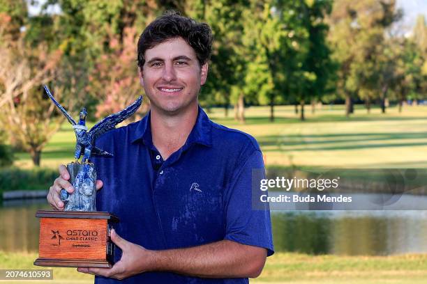 Taylor Dickson of the United States celebrates with the winner's trophy after winning on the 18th hole during the final round of the Astara Chile...