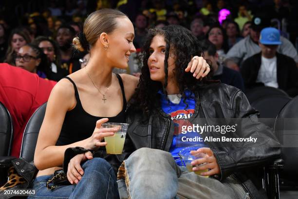 Lily-Rose Depp and musician 070 Shake attend a basketball game between the Los Angeles Lakers and the Minnesota Timberwolves at Crypto.com Arena on...