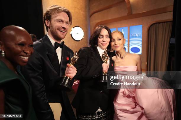 In this handout photo provided by A.M.P.A.S., Finneas O'Connell, Billie Eilish and Ariana Grande are seen backstage during the 96th Annual Academy...