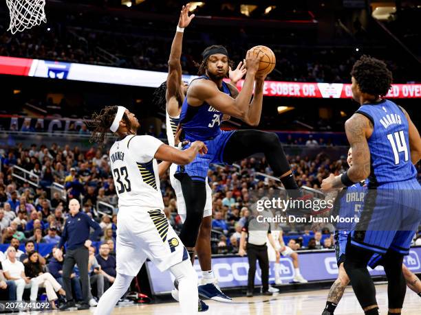 Wendell Carter, Jr. #34 of the Orlando Magic grabs a rebound over Myles Turner of the Indiana Pacers during the game at the Kia Center on March 10,...