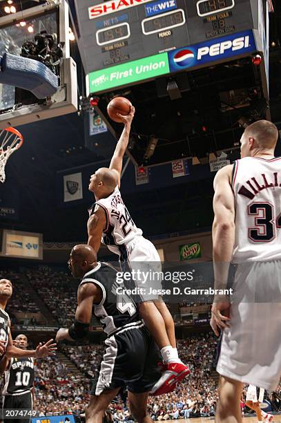 Richard Jefferson of the New Jersey Nets dunks the ball over Kevin Willis of the San Antonio Spurs during game four of the 2003 NBA Finals at the...