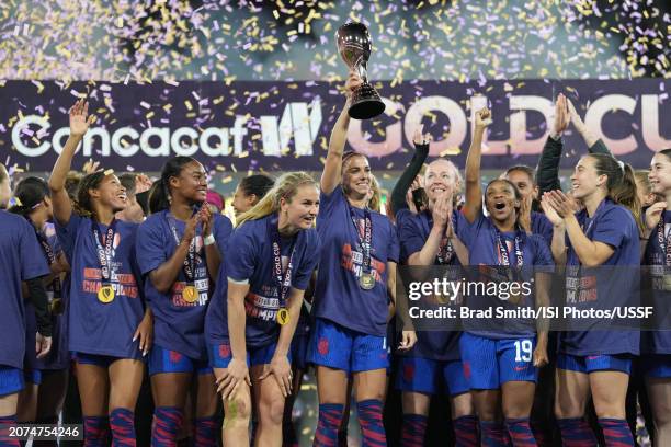 Alex Morgan of the United States lifts the championship trophy as she celebrates with teammates after defeating Brazil during the 2024 Concacaf W...