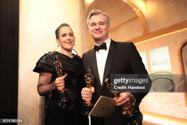 In this handout photo provided by A.M.P.A.S., Emma Thomas and Christopher Nolan are seen backstage during the 96th Annual Academy Awards at Dolby...