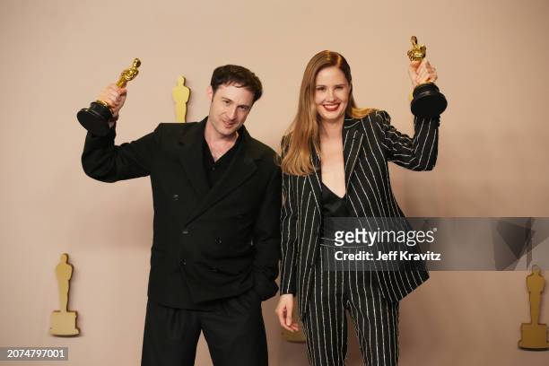 Arthur Harari and Justine Triet, winners of the Original Screenplay Award for “Anatomy of a Fall,” pose in the press room during the 96th Annual...