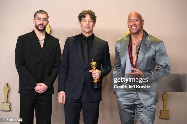 Jonathan Glazer , winner of the Best International Feature Film award for “The Zone of Interest”, poses with Bad Bunny and Dwayne Johnson pose in the...