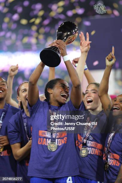 Naomi Girma of the United States lifts the championship trophy as she celebrates with teammates after defeating Brazil during the 2024 Concacaf W...