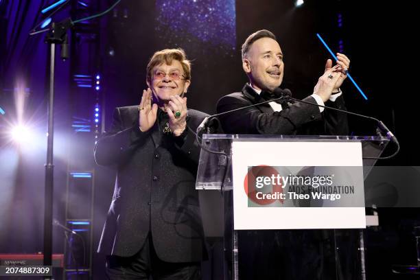 Elton John and David Furnish speak onstage at the Elton John AIDS Foundation's 32nd Annual Academy Awards Viewing Party on March 10, 2024 in West...