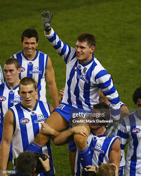 Jason McCartney of the Kangaroos is carried off the ground after announcing his retirment after the round 11 AFL match between the Kangaroos and the...