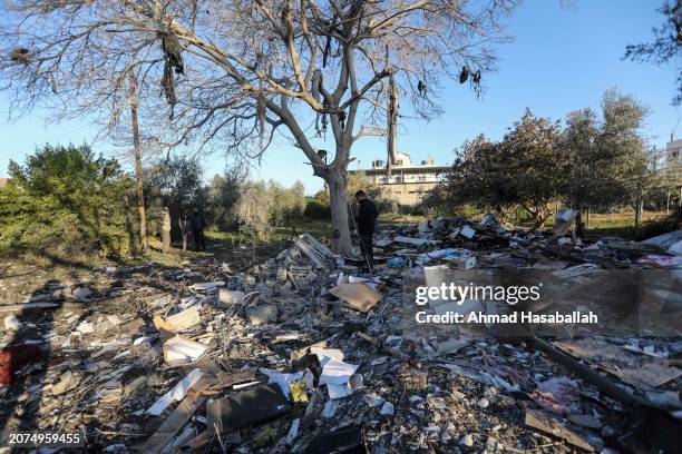 People inspect damage and recover items from their homes following Israeli air strikes on March 11, 2024 in Rafah, Gaza. The United States and other...