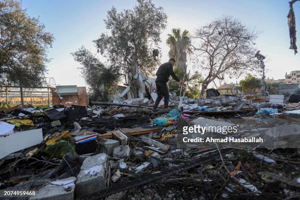 People inspect damage and recover items from their homes following Israeli air strikes on March 11, 2024 in Rafah, Gaza. The United States and other...