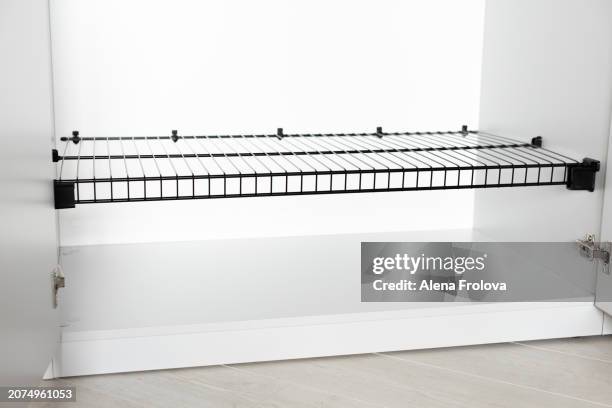 wardrobe with empty shelves in the bedroom concept of a new home cleaning cleanliness conceptual image of empty wooden coat hangers in a closet - collection backstage stock pictures, royalty-free photos & images