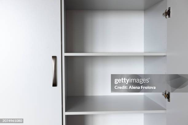 wardrobe with empty shelves in the bedroom concept of a new home cleaning cleanliness conceptual image of empty wooden coat hangers in a closet - collection backstage stock pictures, royalty-free photos & images