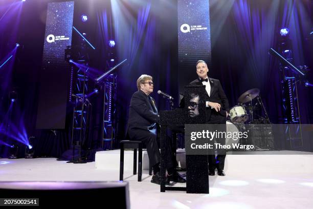 Elton John and David Furnish onstage during the Elton John AIDS Foundation's 32nd Annual Academy Awards Viewing Party on March 10, 2024 in West...