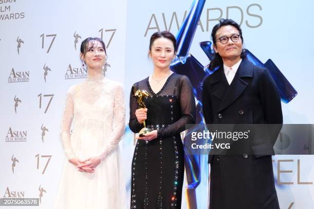 Actress Isabella Leong and actor Gordon Lam Ka-tung present Best Actress award to actress Jiang Qinqin during the 17th Asian Film Awards on March 10,...