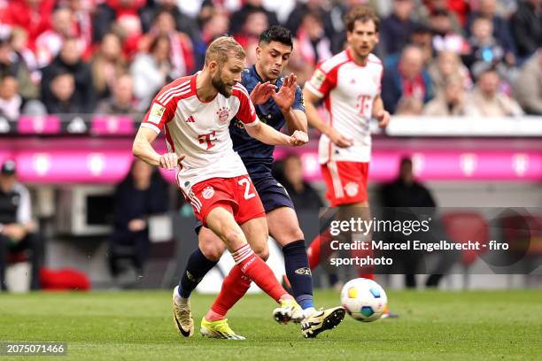 Konrad Laimer of FC Bayern München and Nadiem Amiri of 1. FSV Mainz 05 compete for the ball during the Bundesliga match between FC Bayern München and...