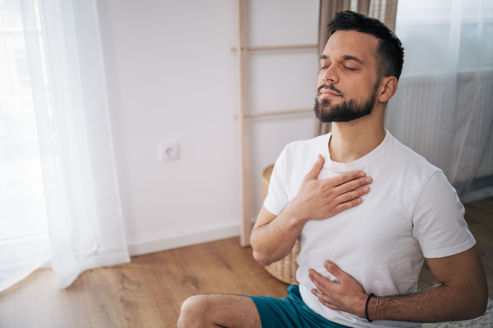 A man practices yoga at home. A man practices yoga at home.