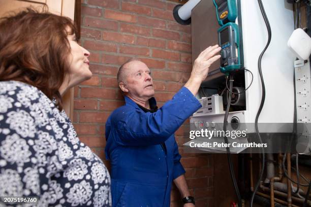 repairman running tests to a gas boiler - home interior stock pictures, royalty-free photos & images