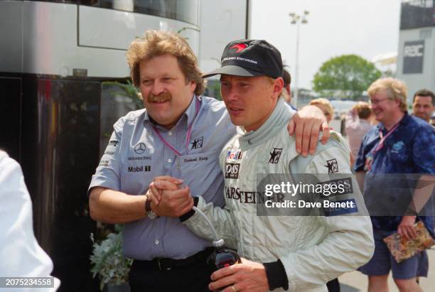 German Vice president of Mercedes-Benz Motorsport Norbert Haug with Finnish racing driver Mika Häkkinen at the 1999 British Grand Prix, Silverstone...