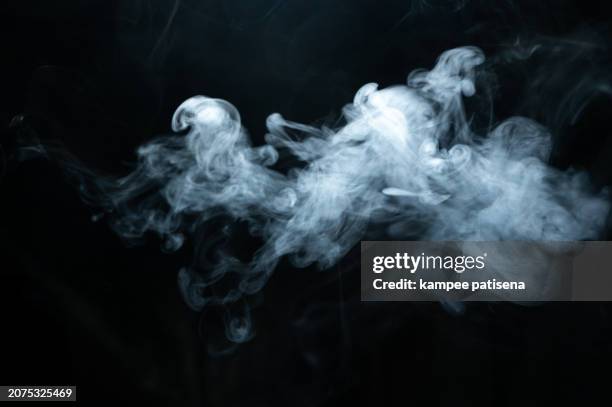 a cloud of smoke is billowing out of a pipe - rook stockfoto's en -beelden