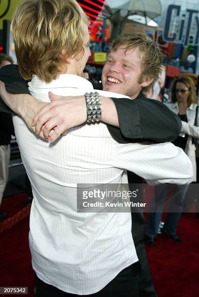 Actors Derek Richardson and Elden Henson greet each other at the premiere of "Dumb and Dumberer: When Harry Met Lloyd" at the Loews Universal City on...