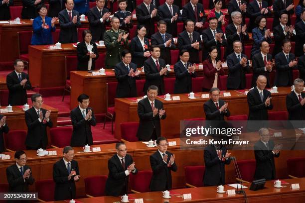 Chinese President Xi Jinping and other senior leaders applaud at the end of the closing session of the NPC, or National Peoples Congress at the Great...