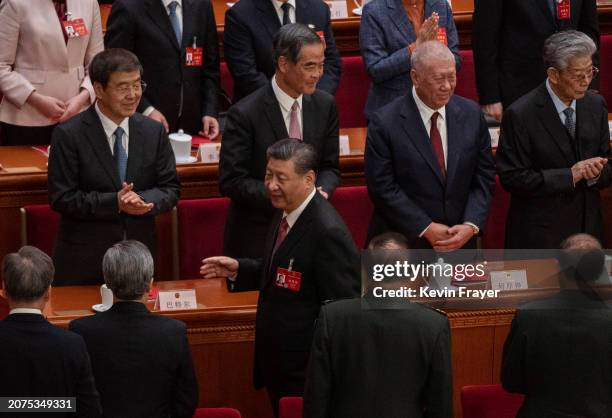 Chinese President Xi Jinping walks by delegates as he leaves the closing session of the NPC, or National Peoples Congress at the Great Hall of the...