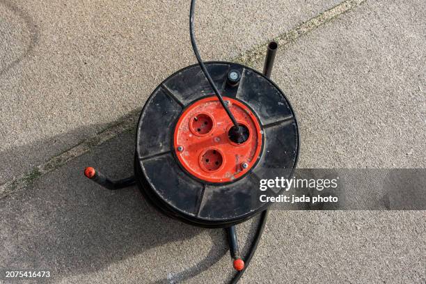 black orange power distributor reel - black power cable stock pictures, royalty-free photos & images