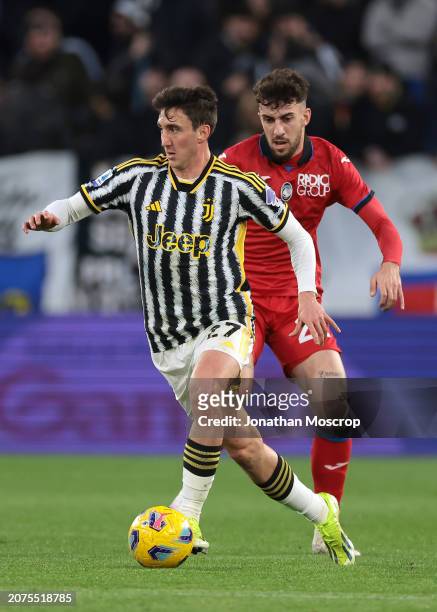 Andrea Cambiaso of Juventus is pursued by Matteo Ruggieri of Atalanta during the Serie A TIM match between Juventus and Atalanta BC - Serie A TIM at...