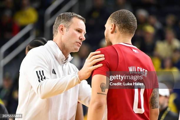 Head coach Fred Hoiberg of the Nebraska Cornhuskers talks with C.J. Wilcher of the Nebraska Cornhuskers against the Michigan Wolverines during the...
