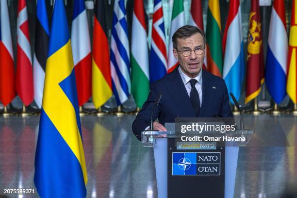 Swedish Prime Minister Ulf Kristersson gives a press conference before the flag-raising ceremony to mark Sweden's accession to NATO at the NATO...