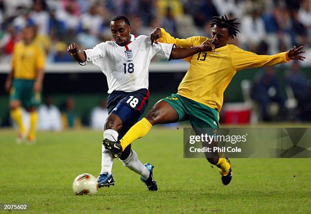 Darius Vassell of England takes the ball past Jabulani Mendu of South Africa during the International Friendly match held on May 22, 2003 at The ABSA...