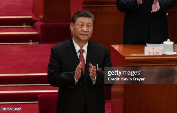 Chinese President Xi Jinping, applauds at the closing session of the NPC, or National Peoples Congress at the Great Hall of the People on March 11,...