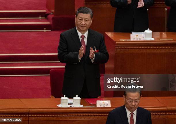 Chinese President Xi Jinping, applauds NPC Chairman Zhao Leji, bottom, at the closing session of the NPC, or National Peoples Congress at the Great...
