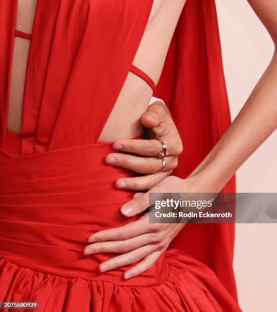 Juanpa Zurita and Macarena Achaga, jewellery detail, attend the 96th Annual Academy Awards on March 10, 2024 in Hollywood, California.