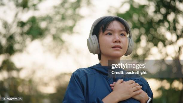 breathing inhaling at nature. - girl with hand on chest stock pictures, royalty-free photos & images