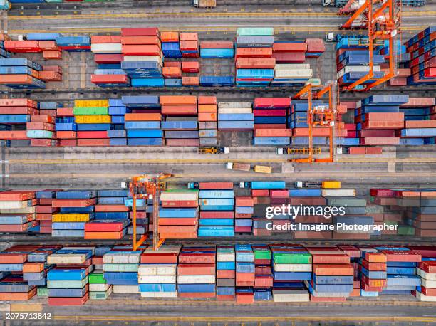 aerial top view, many colorful containers are placed in the port. international cargo ship in warehouse, import, export in port, global shipping, logistics business delivery to the port by crane. - shipping container top view - fotografias e filmes do acervo