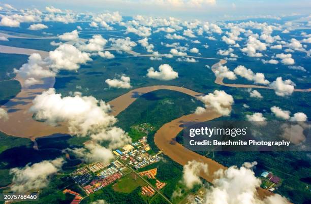 aerial view of rivers ,land, buildings and puffs of clouds seen from an aeroplane window flying over sibu, sarawak, malaysia - sarawak state stock pictures, royalty-free photos & images