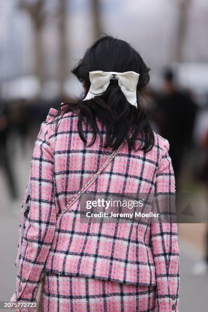 Susanna Lau seen wearing a pink tweed jacket with matching mini skirt, light blue cardigan, pink decorated Chanel bag, white tights, light blue high...