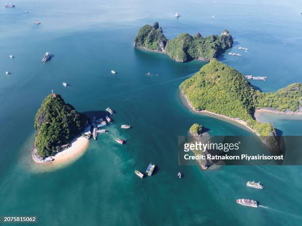aerial drone day light blue sky scene of tourist ship with rock mountain on the sea at ha long bay, north of vietnam - list of islands by highest point stock pictures, royalty-free photos & images