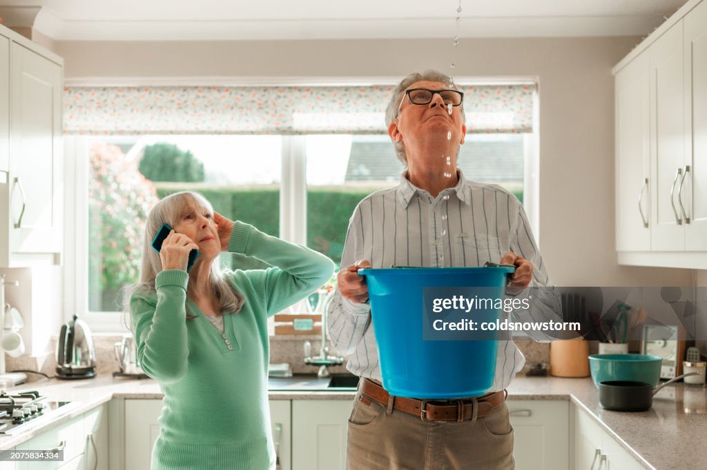 Worried home owners dealing with water leak in the kitchen